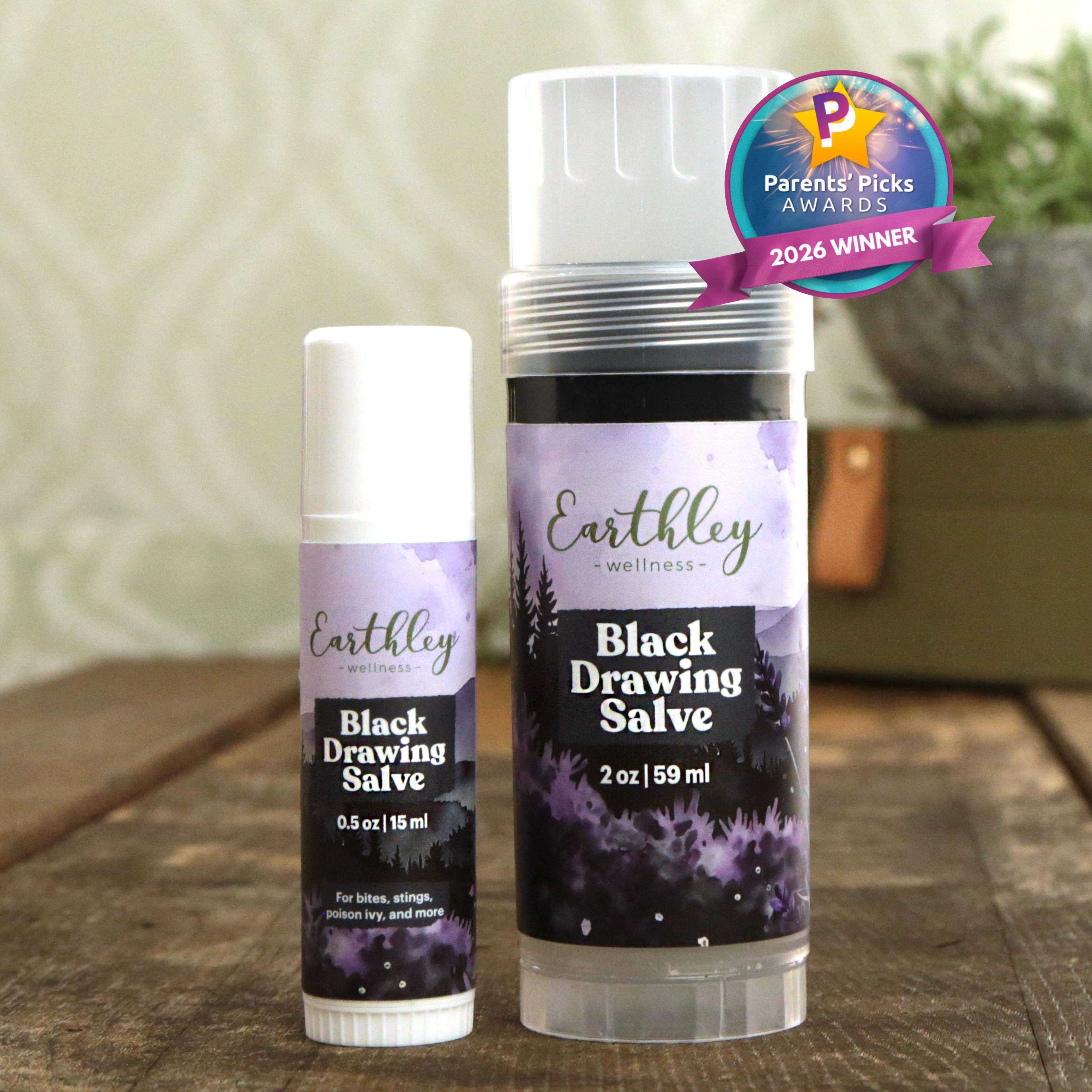 Two Earthley Black Drawing Salve tubes in 0.5oz and 2oz sizes with purple forest-themed labels and Parents' Picks 2026 Winner badge