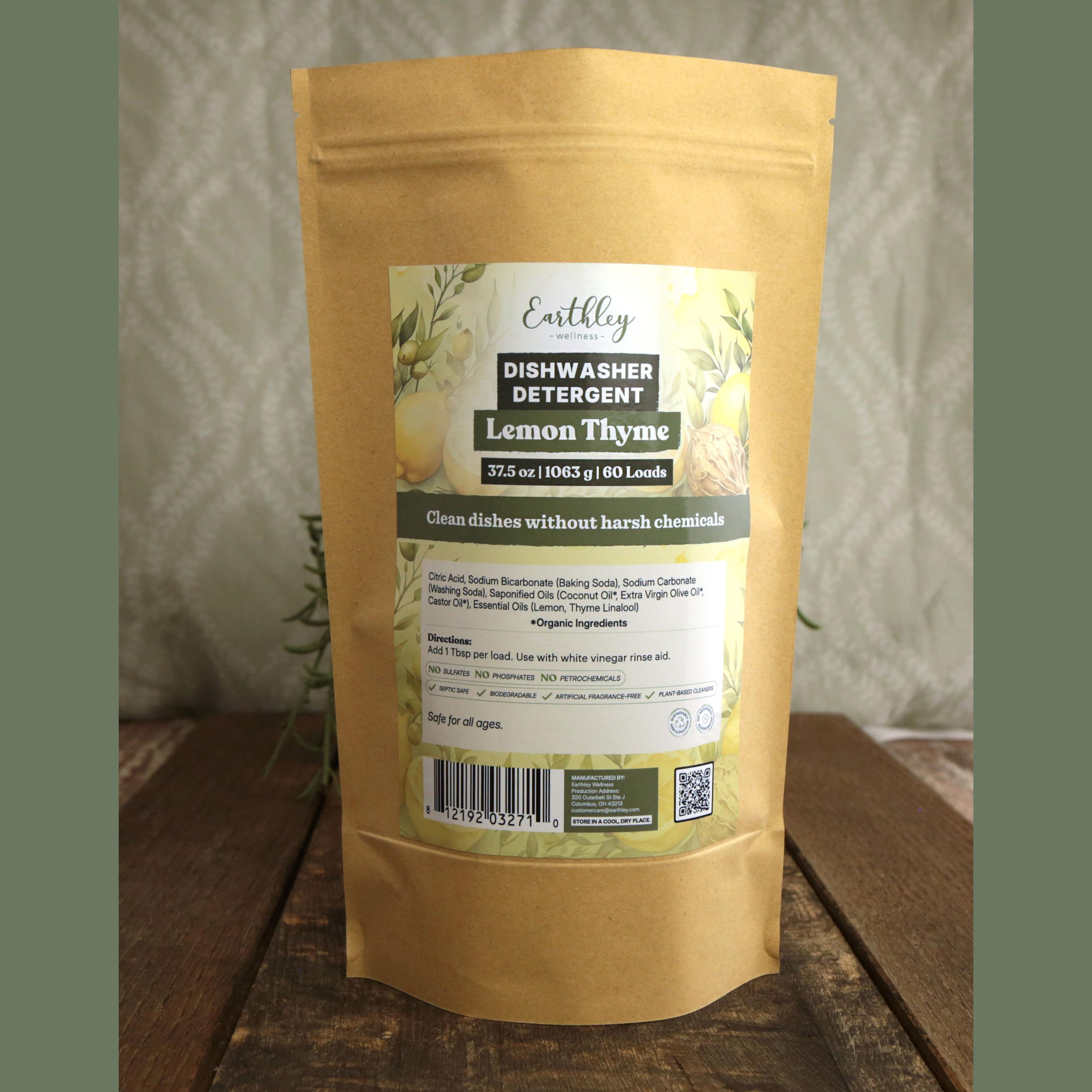 Earthley Dishwasher Detergent Lemon Thyme 37.5 oz kraft stand-up pouch with botanical label featuring lemons, thyme, and herbs, 60 loads, clean dishes without harsh chemicals, on wooden surface with greenery