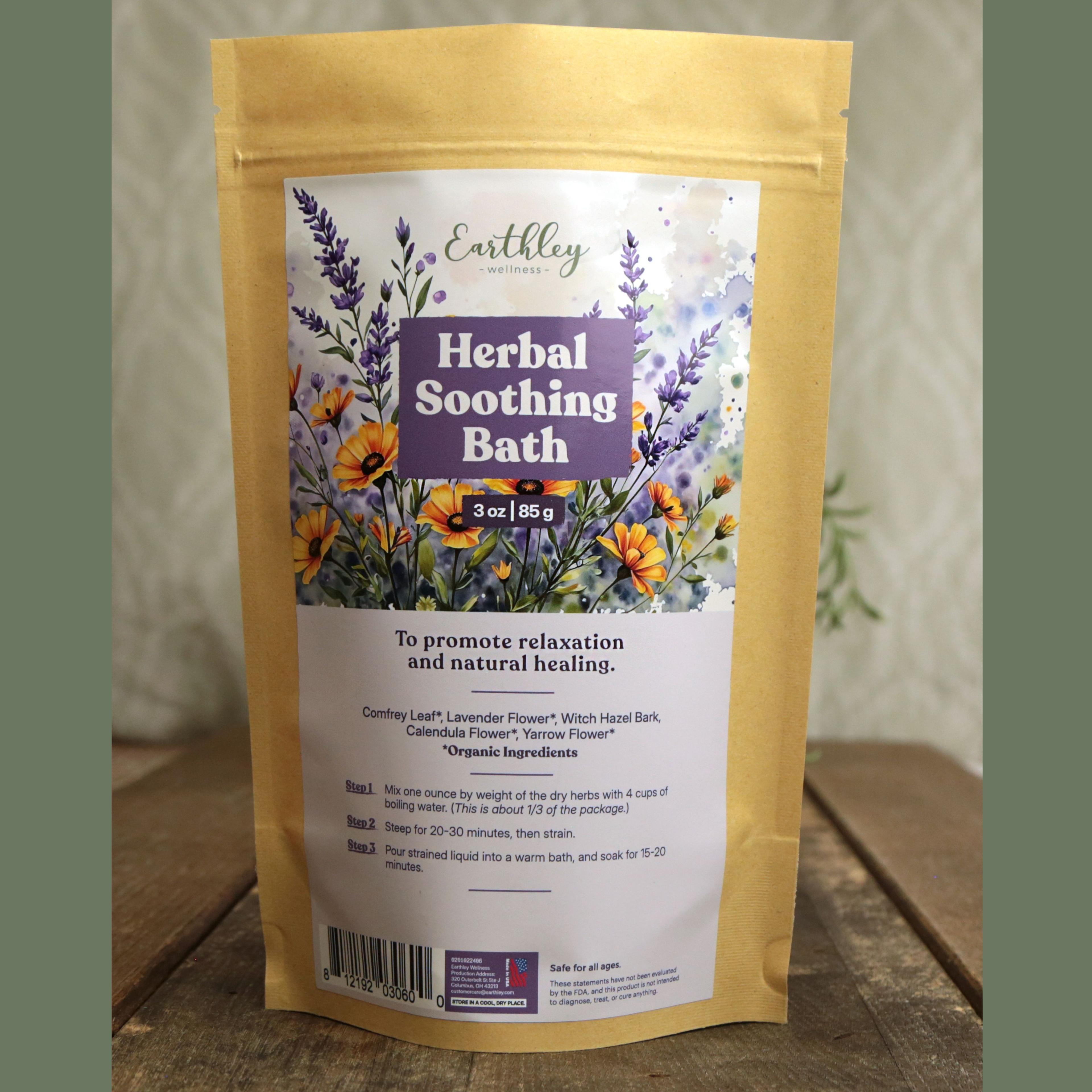 Earthley Herbal Soothing Bath 3 oz kraft stand-up pouch with floral label featuring lavender, calendula, and orange wildflowers, with directions for relaxation and natural healing, on wooden surface