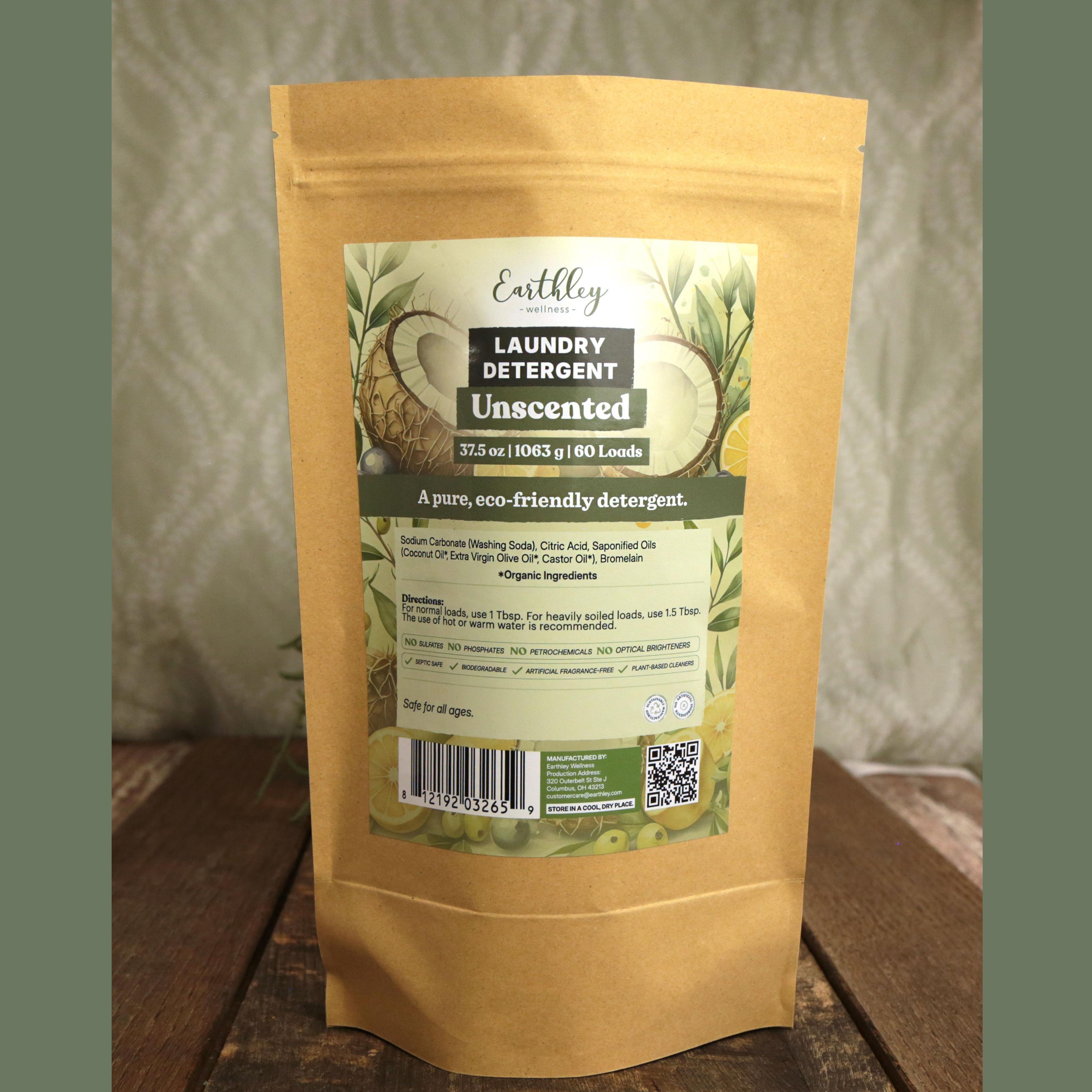 Earthley Laundry Detergent Unscented 37.5 oz kraft stand-up pouch with botanical label featuring coconuts, olives, and citrus, 60 loads, eco-friendly formula, on wooden surface