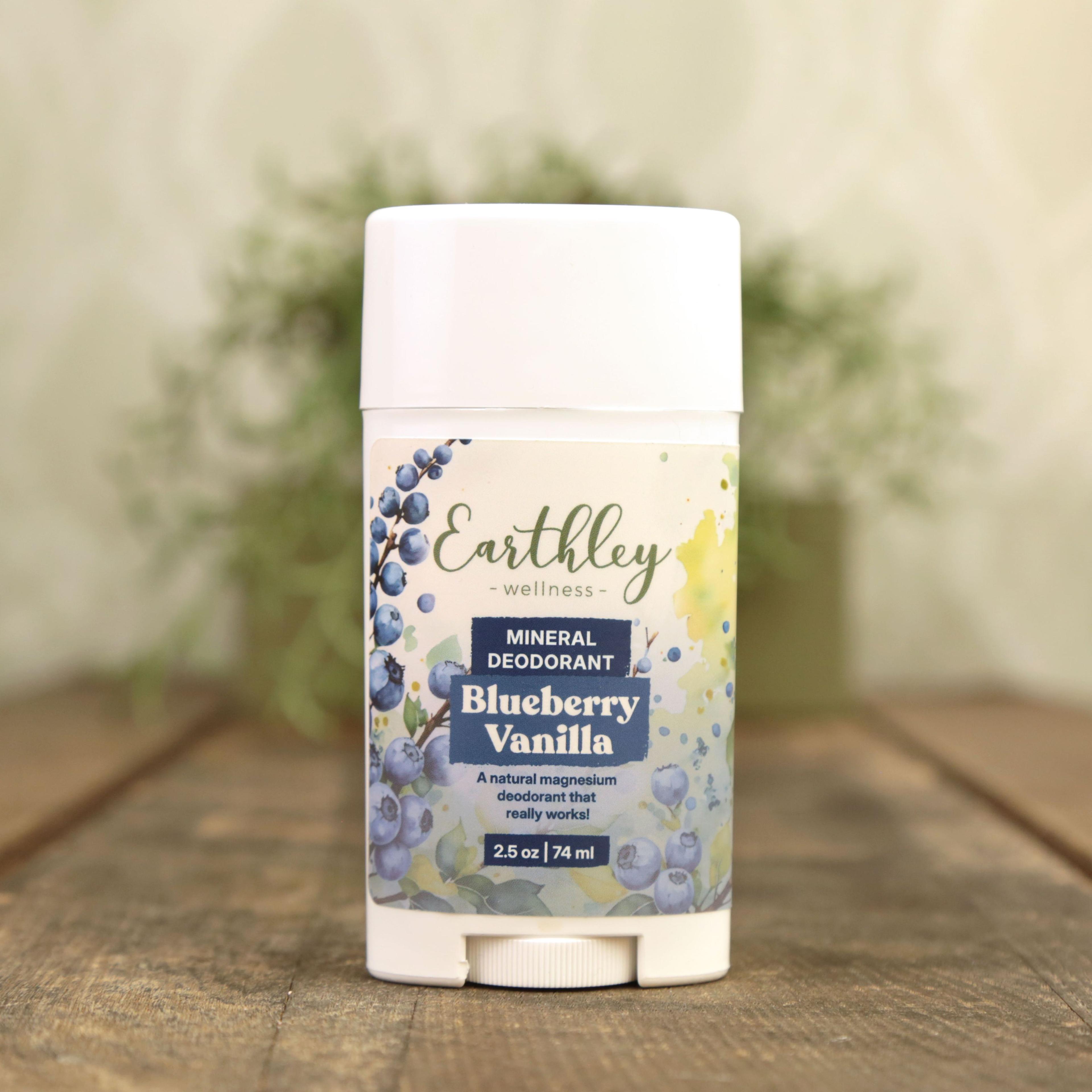 Earthley Wellness Blueberry Vanilla mineral deodorant stick with botanical blueberry design on wooden surface