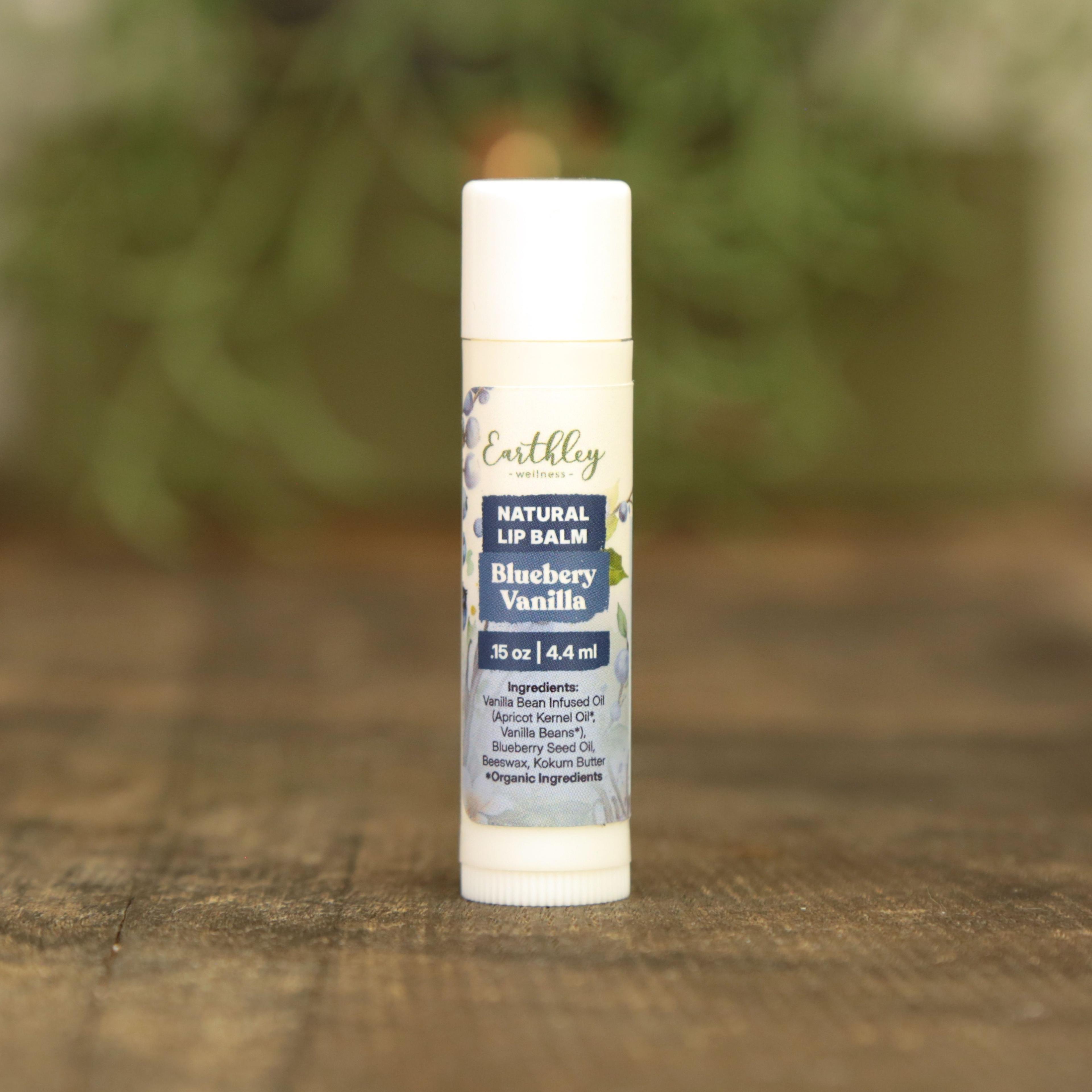 Earthley Wellness Natural Lip Balm in Blueberry Vanilla flavor, white tube with blue label on wooden surface