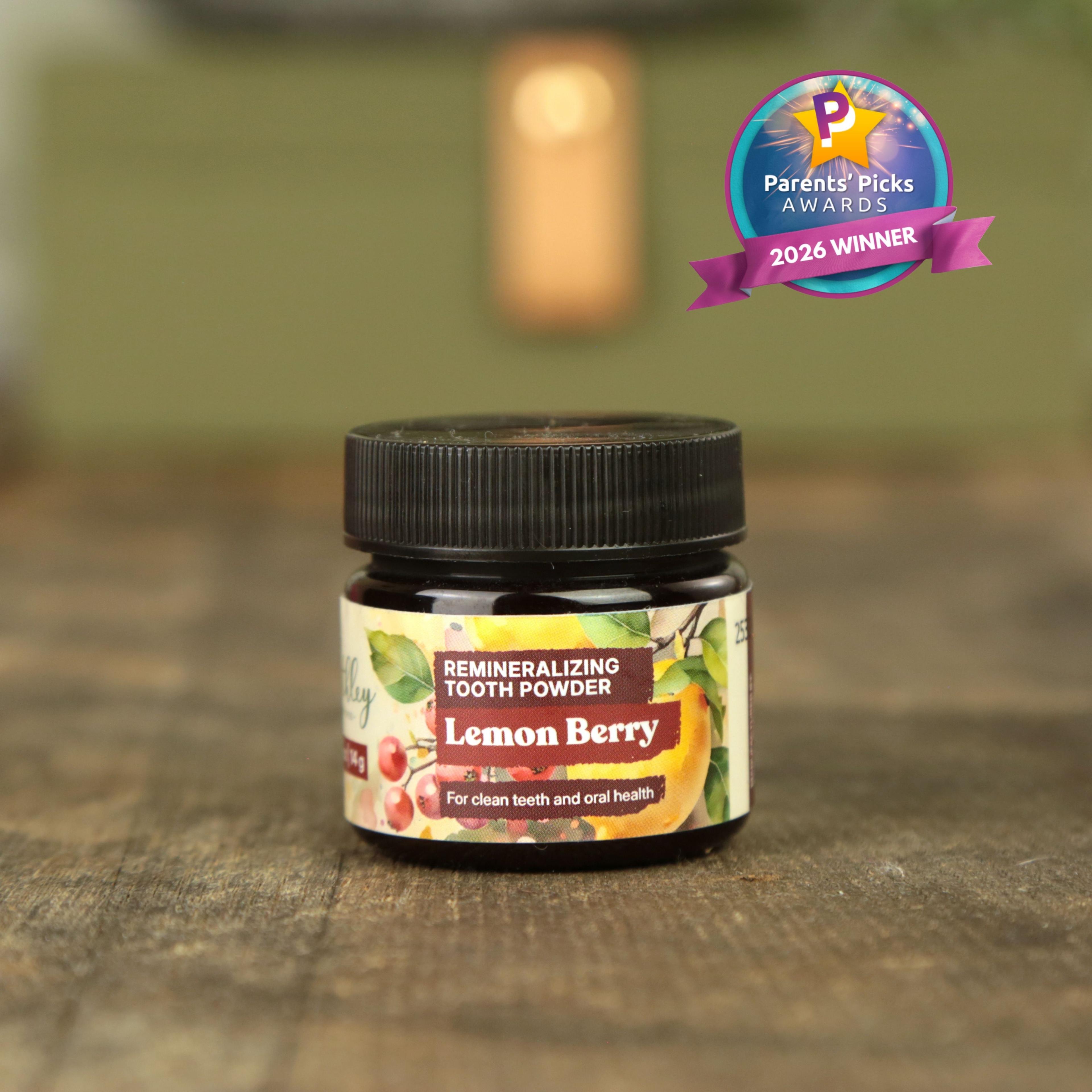 Lemon Berry Remineralizing Tooth Powder jar with Parents' Picks Awards 2026 Winner badge on wooden surface