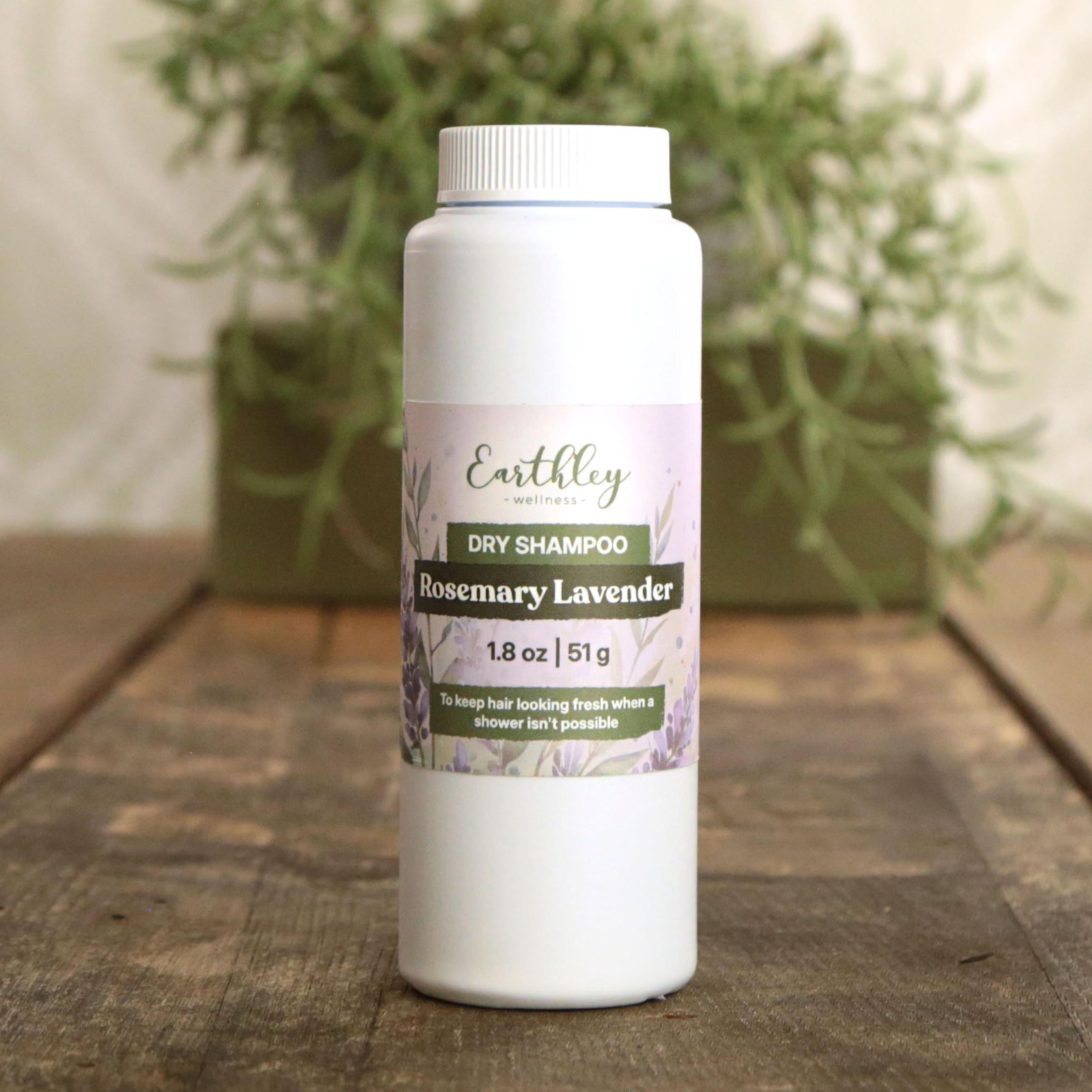 Earthley Rosemary Lavender Dry Shampoo powder in amber glass shaker bottle with purple botanical label for oil-absorbing hair refresh