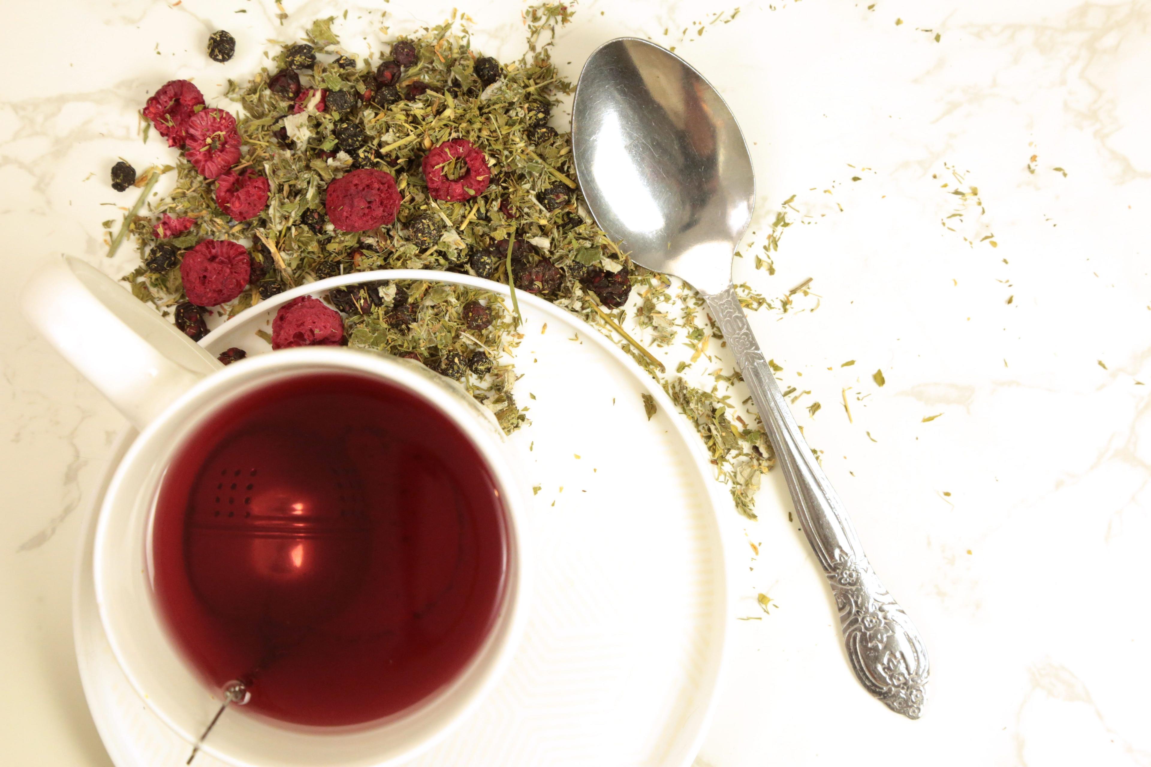 Earthley Berry Balancing Tea product photo showing herbal tea in amber jar
