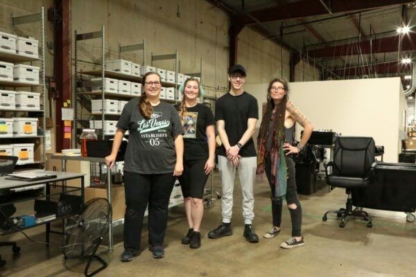 Earthley quality team featuring four employees standing in warehouse workspace