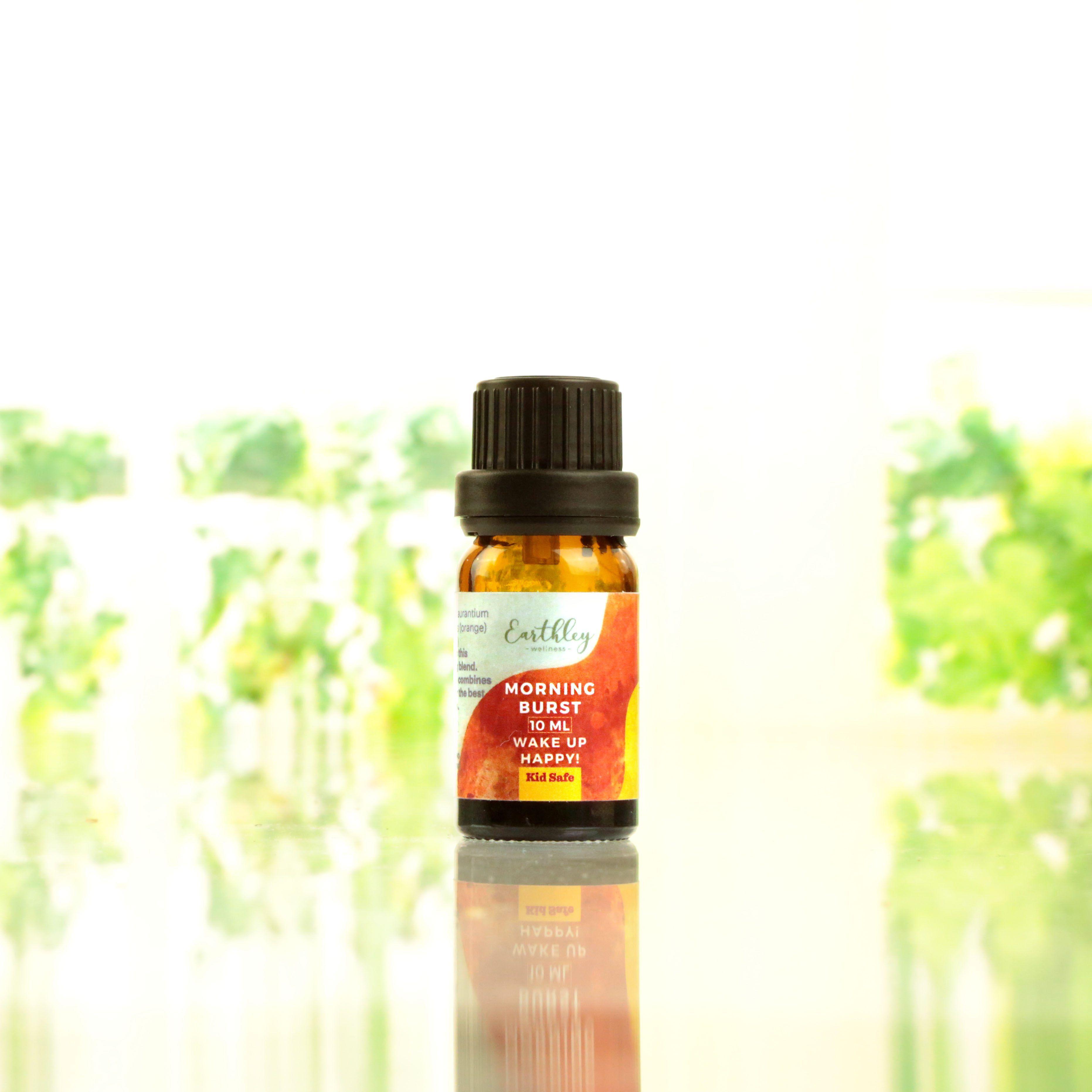Morning Burst essential oil blend 10ml Kid Safe amber bottle with orange watercolor label reading Wake Up Happy on reflective surface